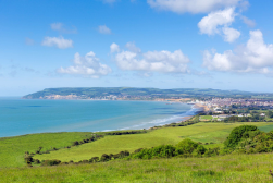 Coastal view of Sandown with green fields and sea